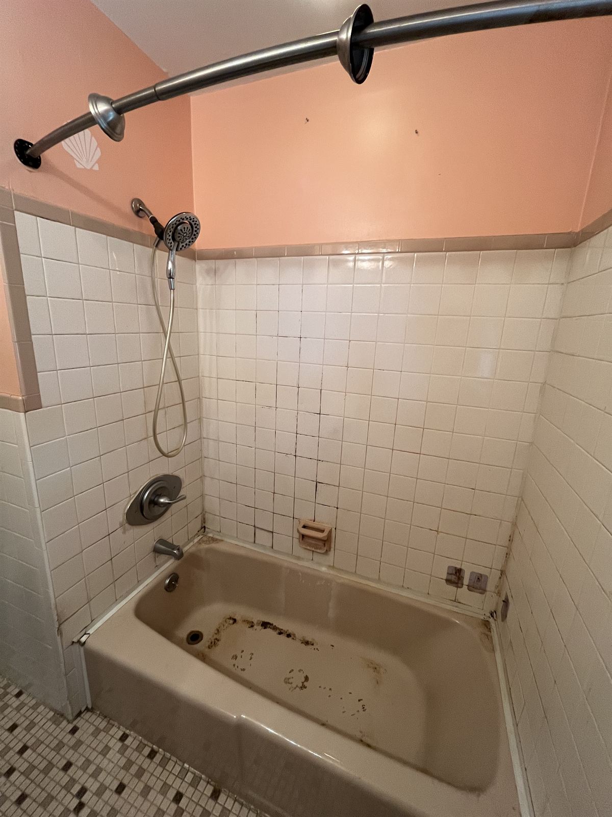 Before: pink 1960s tile with worn almond tub